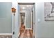 Hallway with hardwood floors and access to bedrooms and bathrooms at 6144 Avenue G, Mc Intosh, FL 32664