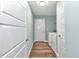 Laundry room adjacent to hallway featuring front-load washer and dryer plus durable wood-look flooring at 6144 Avenue G, Mc Intosh, FL 32664