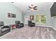 Open living room featuring neutral carpet, light walls and comfortable seating area with plenty of sunlight at 6144 Avenue G, Mc Intosh, FL 32664