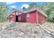 Angled rear exterior view features the covered patio, siding, and freshly graded lawn at 6144 Avenue G, Mc Intosh, FL 32664