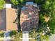 A high angle view shows roof, chimney, and mature trees at 7027 Villa Estelle Drive, Orlando, FL 32819