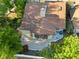 A high angle view shows roof, chimney, backyard patio, and mature trees at 7027 Villa Estelle Drive, Orlando, FL 32819
