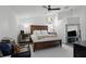 Bright bedroom featuring a ceiling fan, a unique window, and a large bed at 7027 Villa Estelle Drive, Orlando, FL 32819