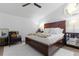 Cozy bedroom with a ceiling fan, a unique window, and a large bed at 7027 Villa Estelle Drive, Orlando, FL 32819