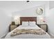 Bright bedroom featuring a ceiling fan, a unique window, and matching nightstands at 7027 Villa Estelle Drive, Orlando, FL 32819