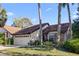 Charming home with a two-car garage, brick accents, and lush landscaping at 7027 Villa Estelle Drive, Orlando, FL 32819