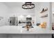 Bright, white kitchen with a large center island, stainless steel appliances, and modern fixtures at 7027 Villa Estelle Drive, Orlando, FL 32819