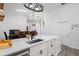 Bright kitchen with a large island, stainless steel sink, and modern lighting fixtures at 7027 Villa Estelle Drive, Orlando, FL 32819