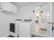 Clean laundry room with a new washer and dryer, cabinets, and easy access to the kitchen at 7027 Villa Estelle Drive, Orlando, FL 32819