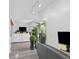 Bright living room featuring wood-look flooring, modern lighting, and views of the outdoor greenery at 7027 Villa Estelle Drive, Orlando, FL 32819