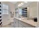 Well-lit bathroom with double vanities, granite countertops, and nautical-themed decor at 7225 Nottingham Reel Ct, St Cloud, FL 34773