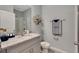 Clean bathroom features updated vanity, stylish geometric decor, and modern shower at 7225 Nottingham Reel Ct, St Cloud, FL 34773