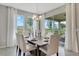 Sunlit dining room features a modern chandelier, table seating for six, and sliding doors to outdoor patio at 7225 Nottingham Reel Ct, St Cloud, FL 34773
