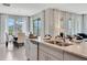 Open kitchen features a breakfast bar overlooking a dining area and living room with gray sectional couch at 7225 Nottingham Reel Ct, St Cloud, FL 34773