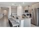 Modern kitchen with a large island, stainless steel appliances, and ample counter space at 7225 Nottingham Reel Ct, St Cloud, FL 34773