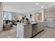 Modern kitchen boasts stainless steel appliances, granite counters, and an open flow to the living area at 7225 Nottingham Reel Ct, St Cloud, FL 34773