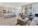Open-concept living room featuring tile floors, modern furnishings, and an open kitchen at 7225 Nottingham Reel Ct, St Cloud, FL 34773
