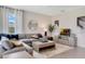 Bright living room features a gray sectional sofa, plush throw pillows, and a stylish rug and decor at 7225 Nottingham Reel Ct, St Cloud, FL 34773