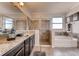 Bright bathroom featuring double vanity, granite countertops, large tub, and glass shower at 7237 Nottingham Reel Ct, St Cloud, FL 34773