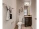 Cozy half bathroom with dark vanity and granite countertop, perfect for guests at 7237 Nottingham Reel Ct, St Cloud, FL 34773