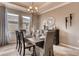 Formal dining room featuring modern decor, a buffet, and large windows with patterned curtains at 7237 Nottingham Reel Ct, St Cloud, FL 34773
