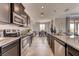 Modern kitchen featuring granite countertops, stainless steel appliances, and open dining area at 7237 Nottingham Reel Ct, St Cloud, FL 34773