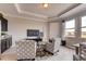 Comfortable seating area with stylish chairs, TV, and ample natural light from the windows at 7237 Nottingham Reel Ct, St Cloud, FL 34773