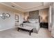 Luxurious main bedroom with tufted headboard, tray ceiling, and decorative mirrors at 7237 Nottingham Reel Ct, St Cloud, FL 34773