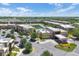 Aerial view of a well maintained condominium community including a pool, lake, and lush greenery at 7645 Recife Dr, Kissimmee, FL 34747