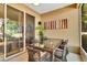 Comfortable outdoor dining area with wicker chairs and glass table on the balcony at 7645 Recife Dr, Kissimmee, FL 34747