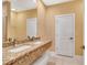 Elegant bathroom with a double sink granite countertop vanity and a glass shower at 7645 Recife Dr, Kissimmee, FL 34747