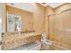 Bright bathroom boasts a single sink vanity with granite countertop and glass-enclosed shower at 7645 Recife Dr, Kissimmee, FL 34747