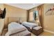 Charming bedroom with twin beds, soft natural light, and seating bench at 7645 Recife Dr, Kissimmee, FL 34747