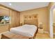 Cozy bedroom features a queen bed, decorative wall art, and a bench for added comfort at 7645 Recife Dr, Kissimmee, FL 34747