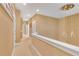 Upper-level hallway offers recessed lighting and access to bedrooms and bathrooms at 7645 Recife Dr, Kissimmee, FL 34747