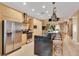 Well-equipped kitchen featuring stainless steel appliances and a central island with bar stools at 7645 Recife Dr, Kissimmee, FL 34747