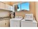 Laundry room has full-size washer, dryer, and storage at 7645 Recife Dr, Kissimmee, FL 34747