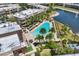 Relaxing community pool with sun loungers, palm trees and a view of the nearby pond and surrounding residences at 7645 Recife Dr, Kissimmee, FL 34747