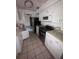 Functional kitchen with white cabinetry, stainless steel appliances, and tiled flooring, ready for customization at 808 Woodling Pl, Altamonte Springs, FL 32701