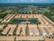 Aerial view of a townhome community with center lakes and pools surrounded by lush landscaping at 810 Greybull Run, Lake Mary, FL 32746