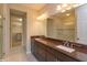 Modern bathroom with dual sinks, granite counters, walk-in glass shower, and luxurious tile flooring at 810 Greybull Run, Lake Mary, FL 32746
