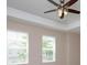 Bedroom featuring two windows, ceiling fan, and neutral paint at 810 Greybull Run, Lake Mary, FL 32746