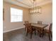 Dining room with modern chandelier, wood floors, and window at 810 Greybull Run, Lake Mary, FL 32746