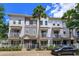 Charming multi-story townhome with a well-manicured lawn and a classic white picket fence at 810 Greybull Run, Lake Mary, FL 32746