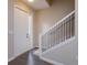 Entryway with wood floors, white door, and staircase with black railings at 810 Greybull Run, Lake Mary, FL 32746