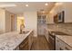Modern kitchen features stainless appliances, gray cabinets, granite countertops, and backsplash at 810 Greybull Run, Lake Mary, FL 32746