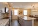 Modern kitchen features stainless appliances, gray cabinets, and a spacious granite island at 810 Greybull Run, Lake Mary, FL 32746