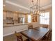 Kitchen and dining area feature wood floors, modern chandelier, and stainless appliances at 810 Greybull Run, Lake Mary, FL 32746