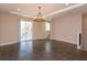 Open living room with sliding glass doors leading to a balcony and hardwood floors at 810 Greybull Run, Lake Mary, FL 32746