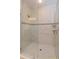 Luxurious glass enclosed shower features tile surround with accent border, tile flooring, and shower head at 810 Greybull Run, Lake Mary, FL 32746